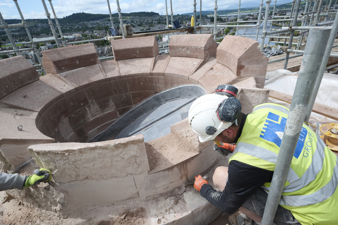 
    Masons replacing and maintaining stonework
    