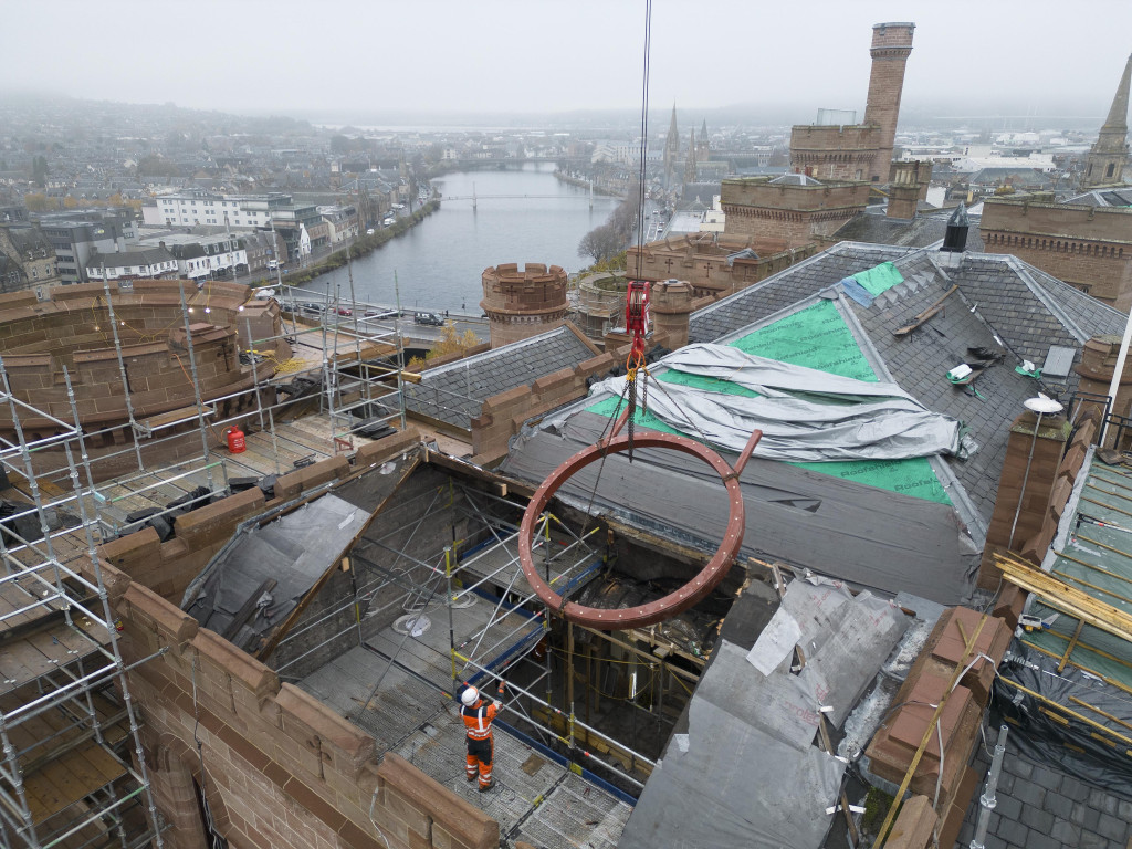 
    The circular steel frame being craned high above the castle's south tower (Credit: High Life Highland / Ewen Weatherspoon)
    