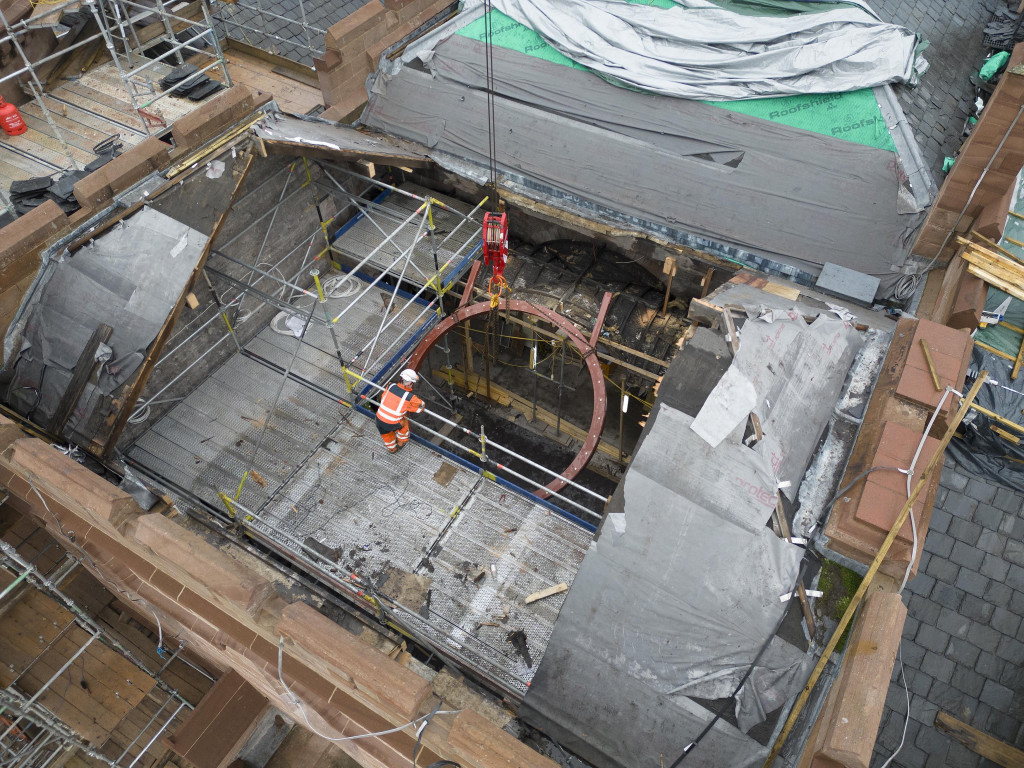 
    The circular frame being lowered in through a roof opening, into the room below the new accessible roof terrace (Credit: High Life Highland / Ewen Weatherspoon)
    